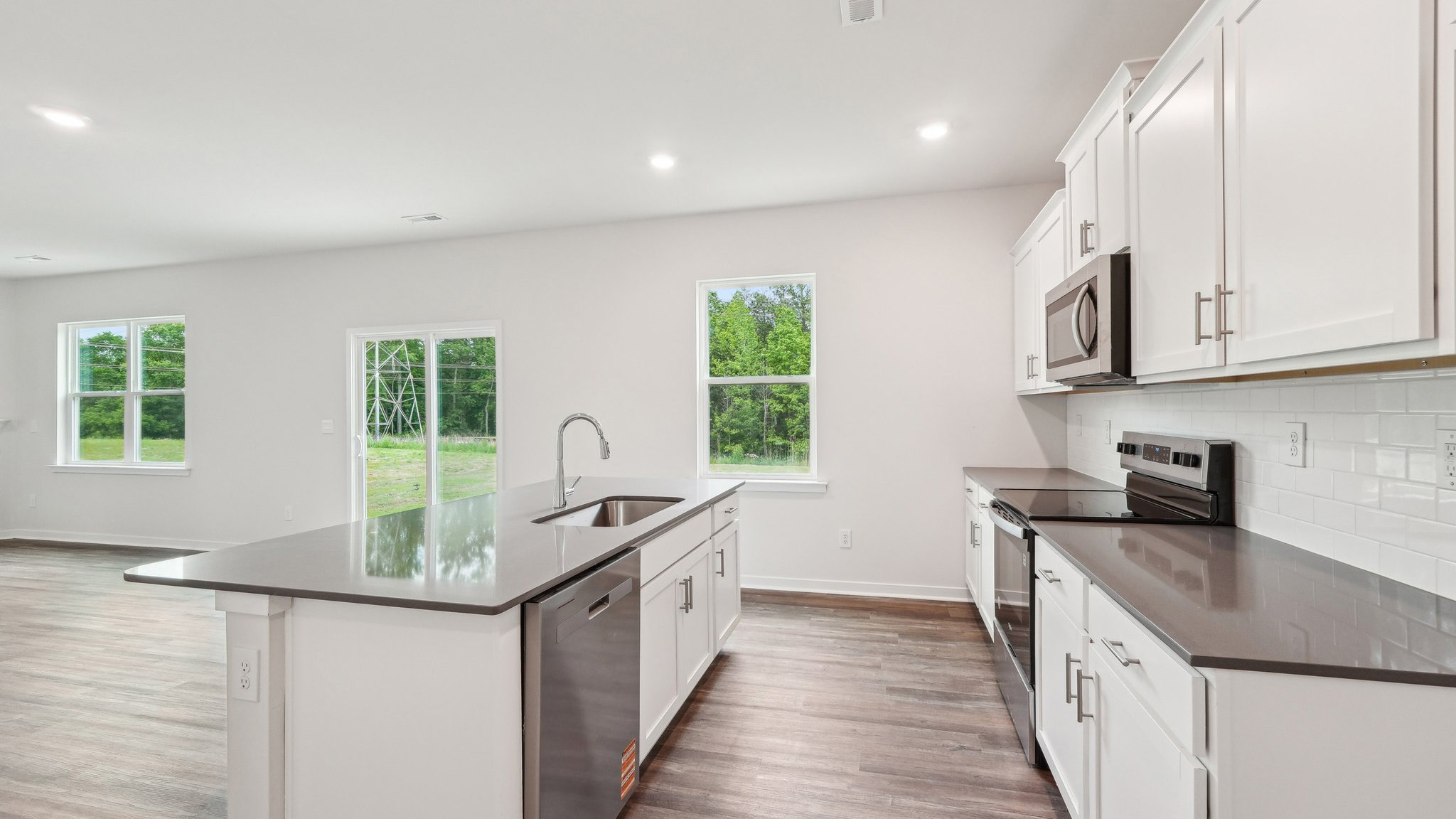 kitchen and island with large window and stainless steel appliances