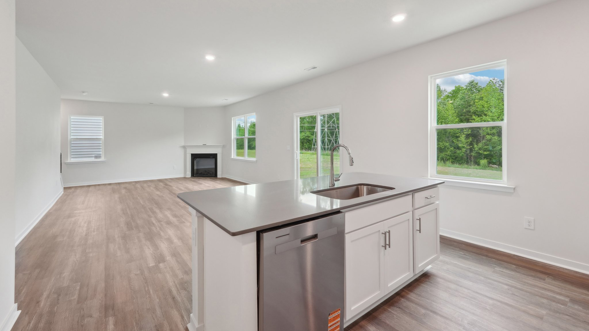kitchen and island with large window and stainless steel appliances