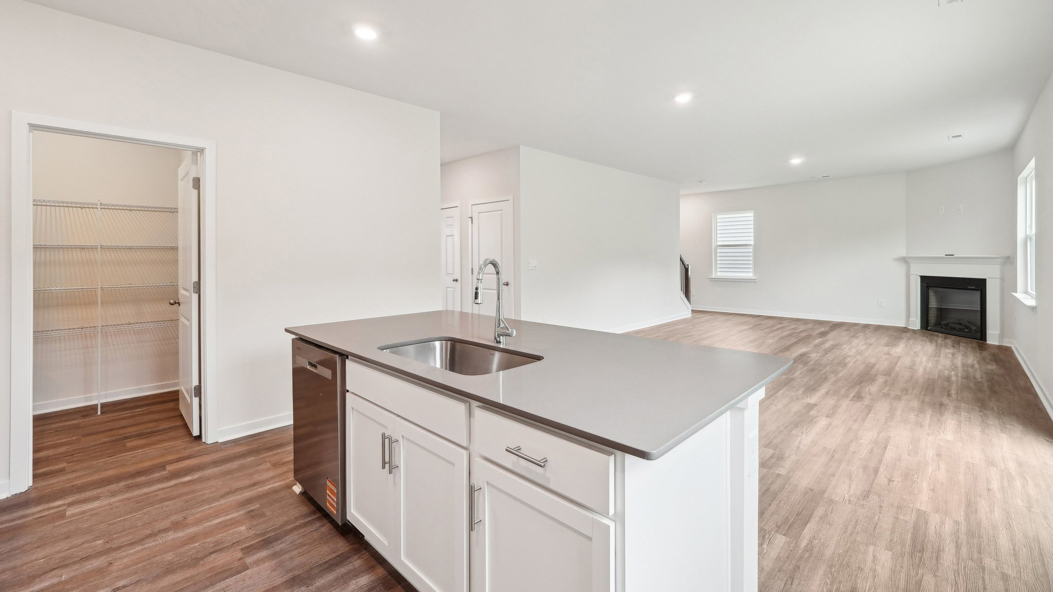 kitchen and island with large window and stainless steel appliances