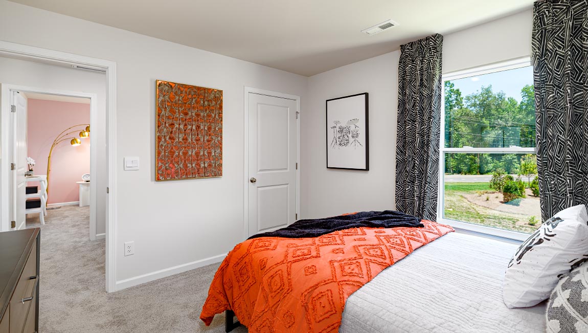 Carpeted bedroom with large window