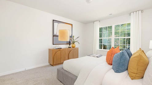 carpeted bedroom with small window