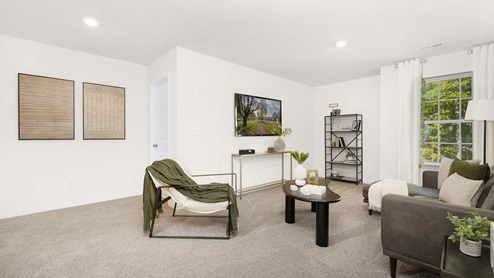 Loft space with large window and carpet