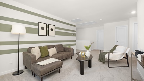 Loft space with large window and carpet