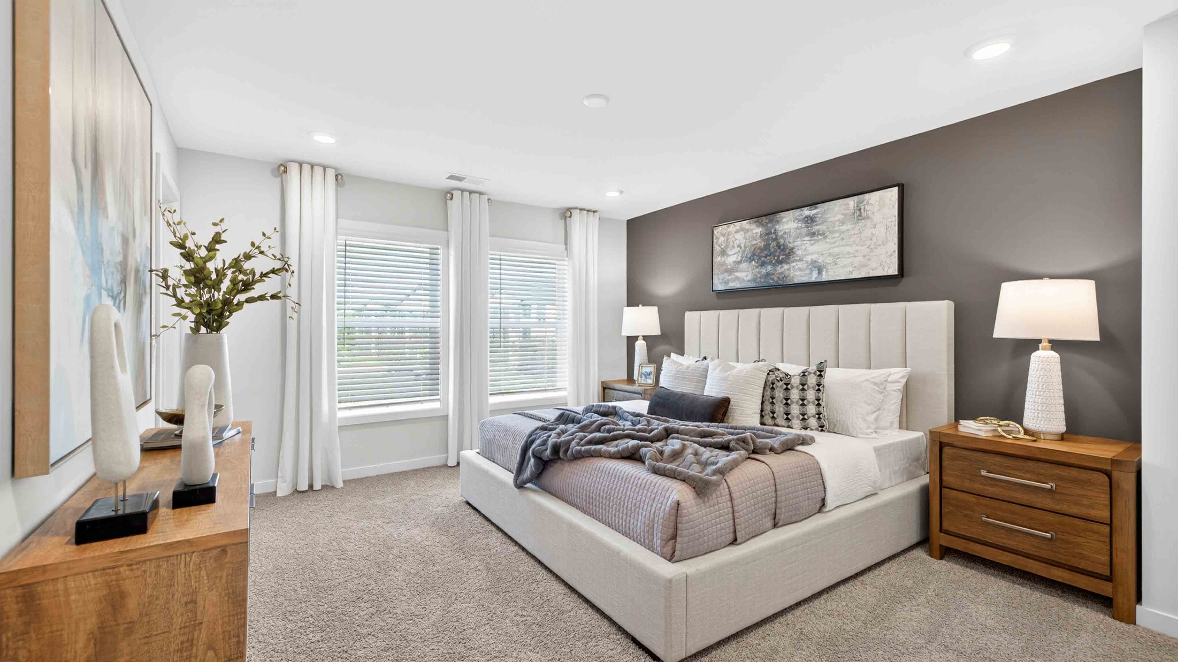 Primary carpeted bedroom with windows