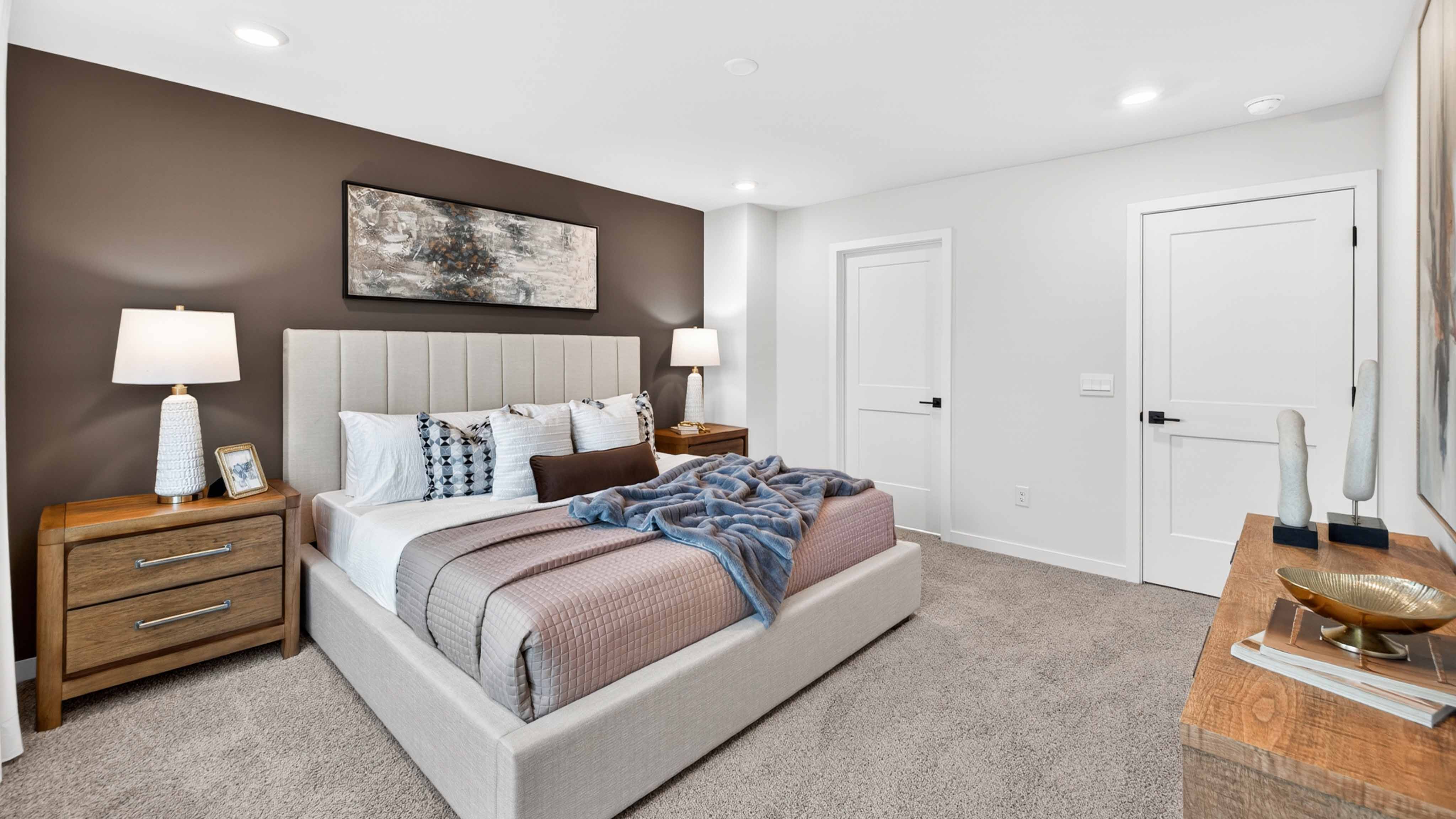 Primary carpeted bedroom with windows