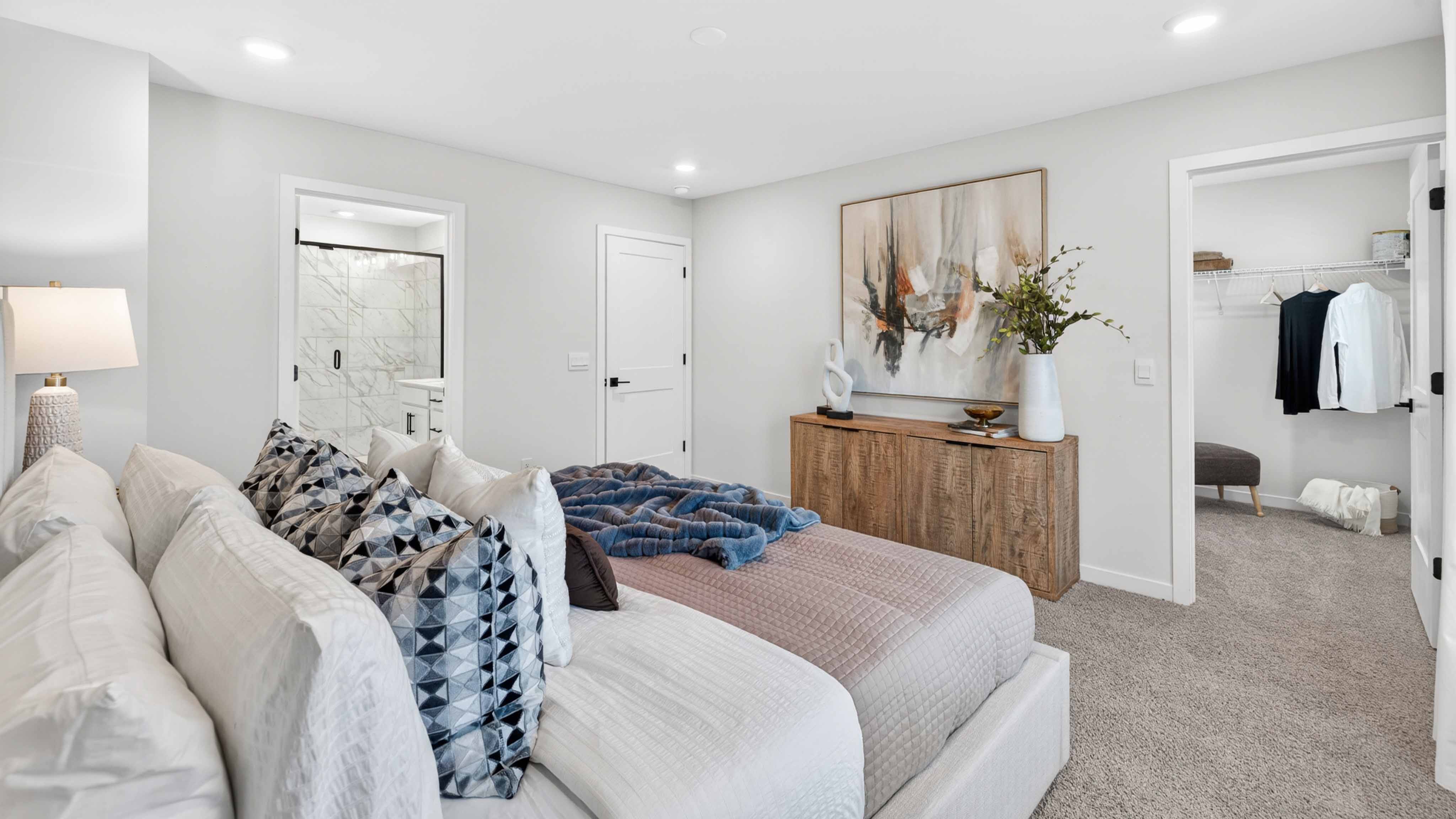 Primary carpeted bedroom with windows