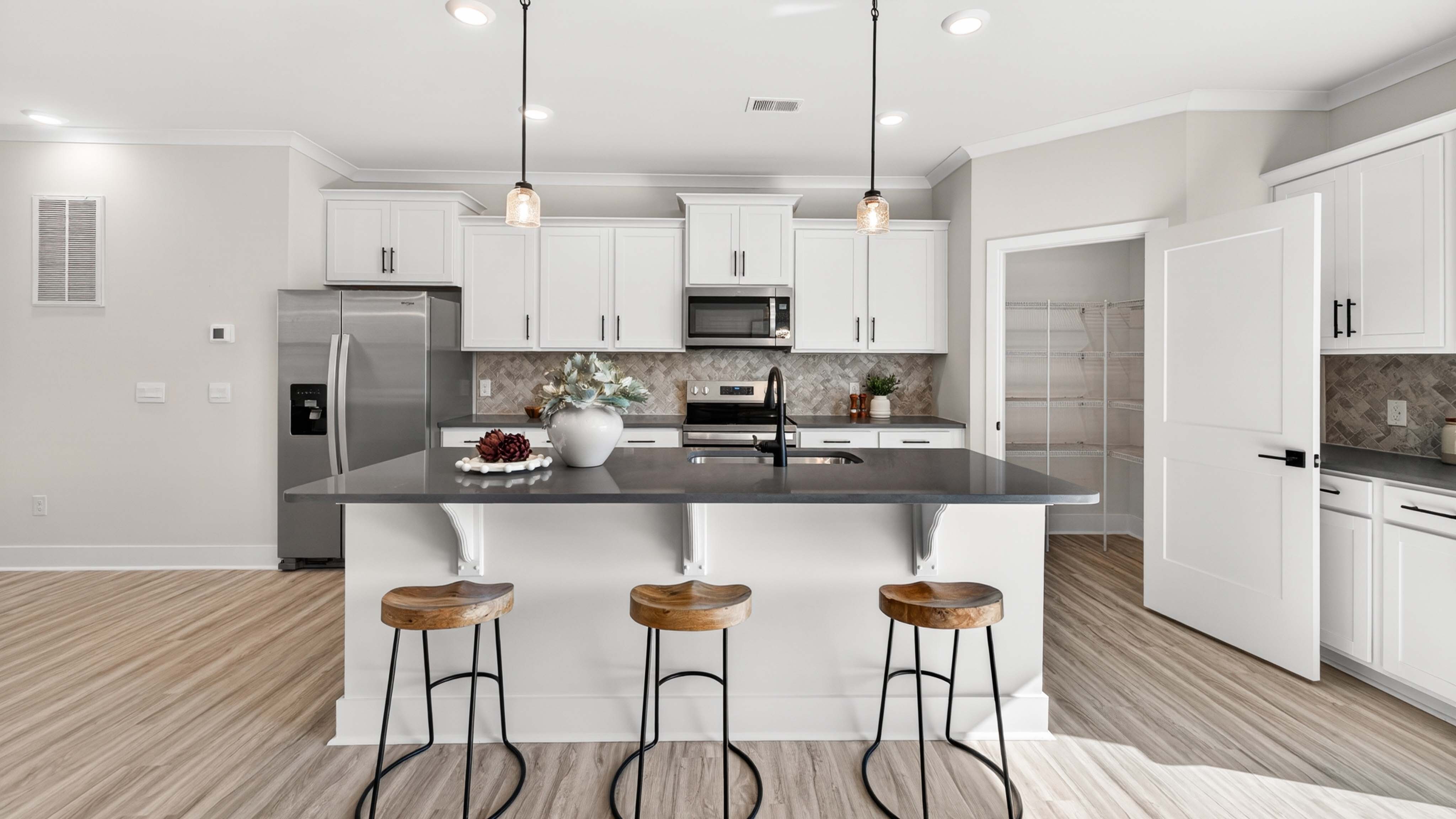 Kitchen and island with stainless steel appliances
