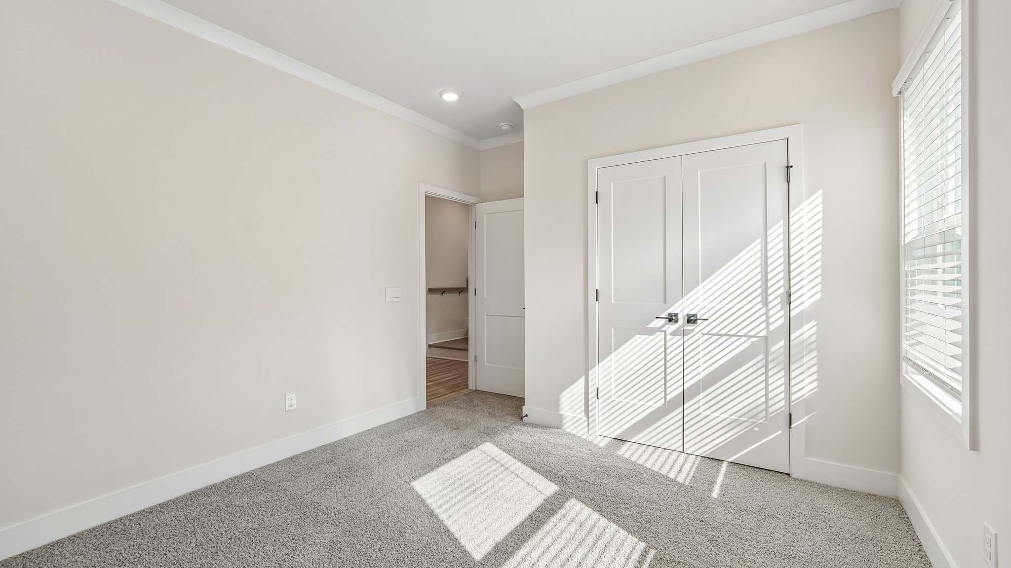 Carpeted bedroom with windows