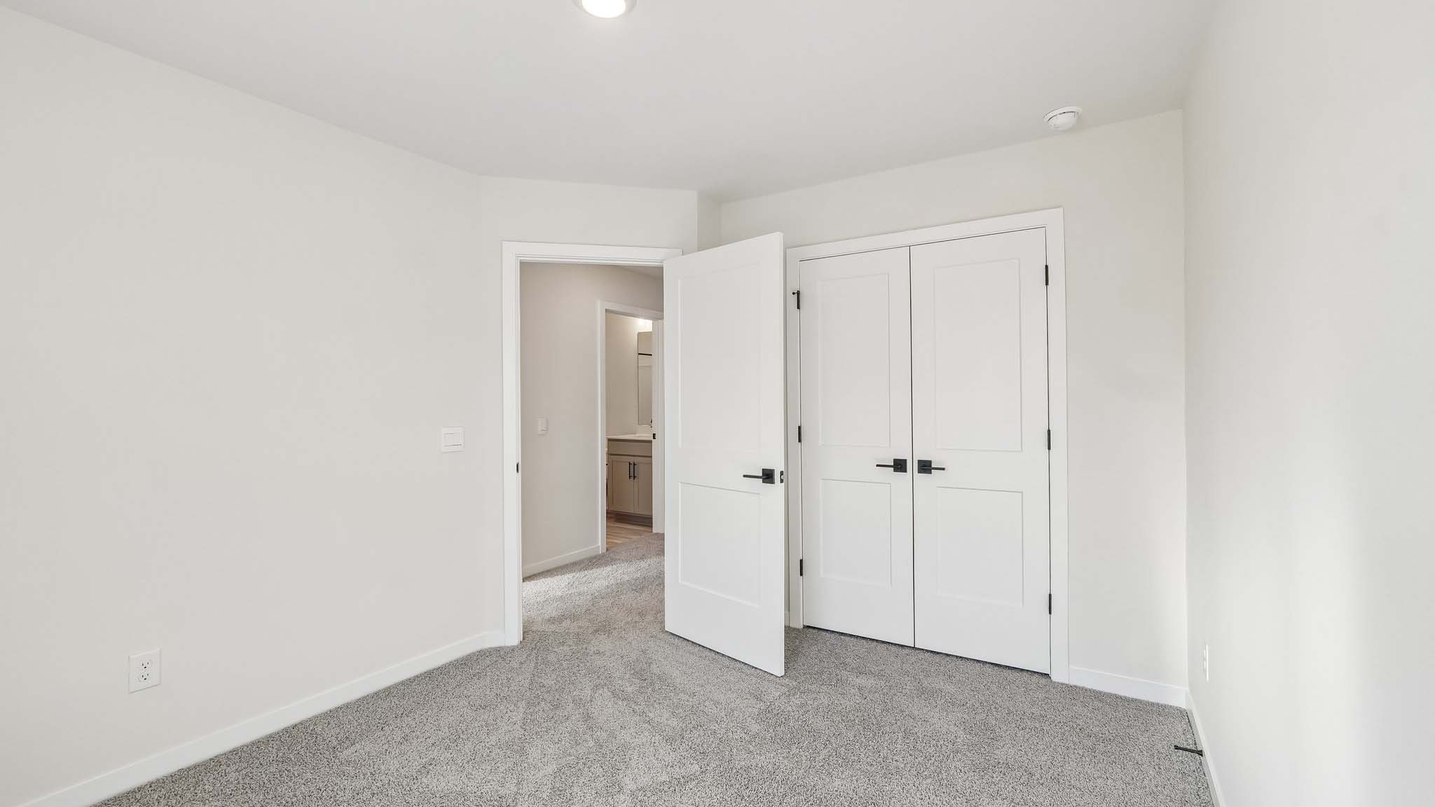 Carpeted bedroom with windows