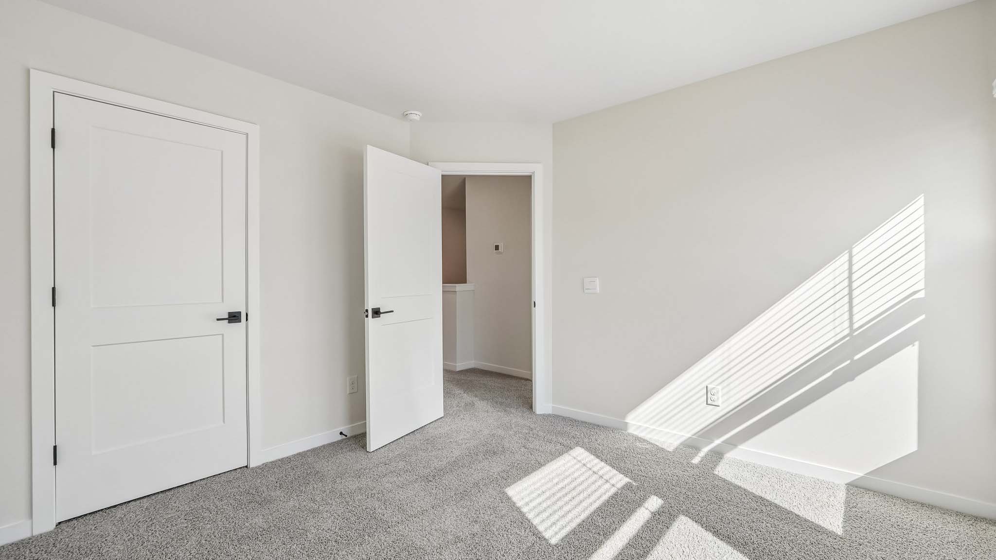 Carpeted bedroom with windows