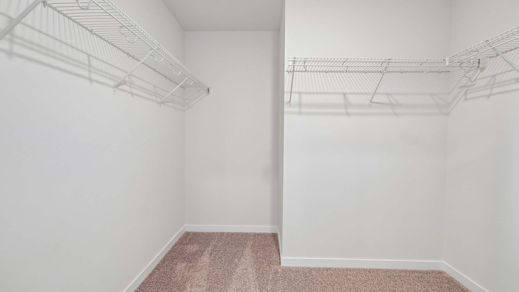 Carpeted bedroom with windows