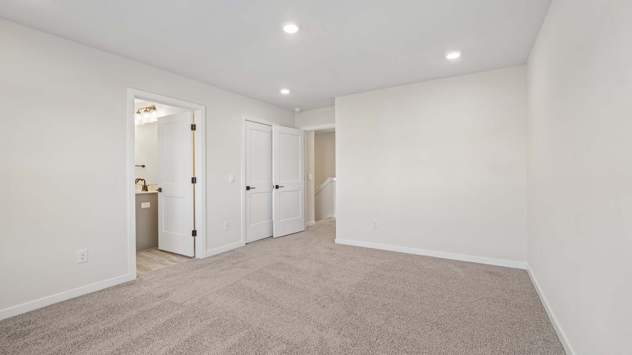 Carpeted bedroom with windows