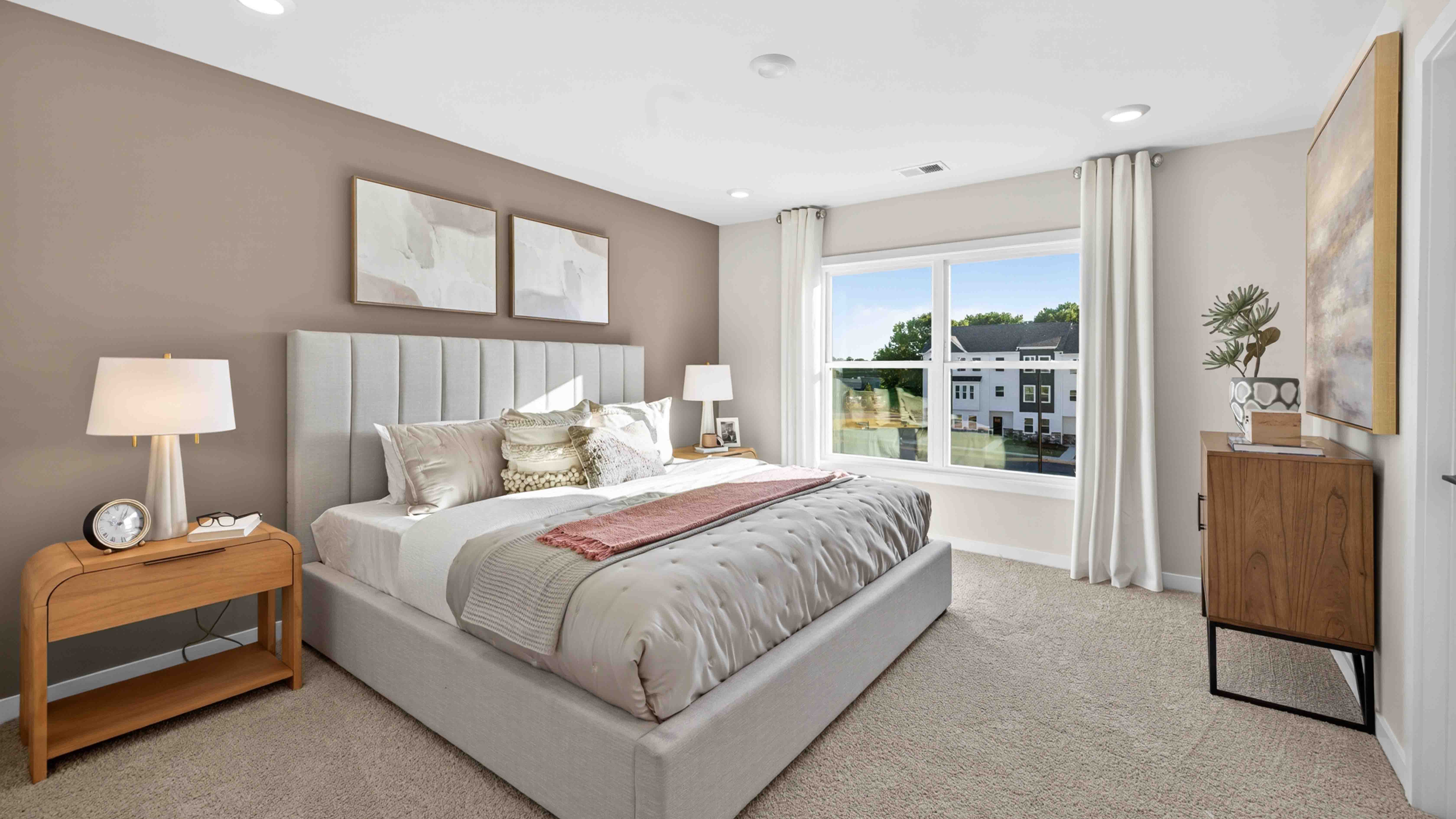 Primary carpeted bedroom with windows