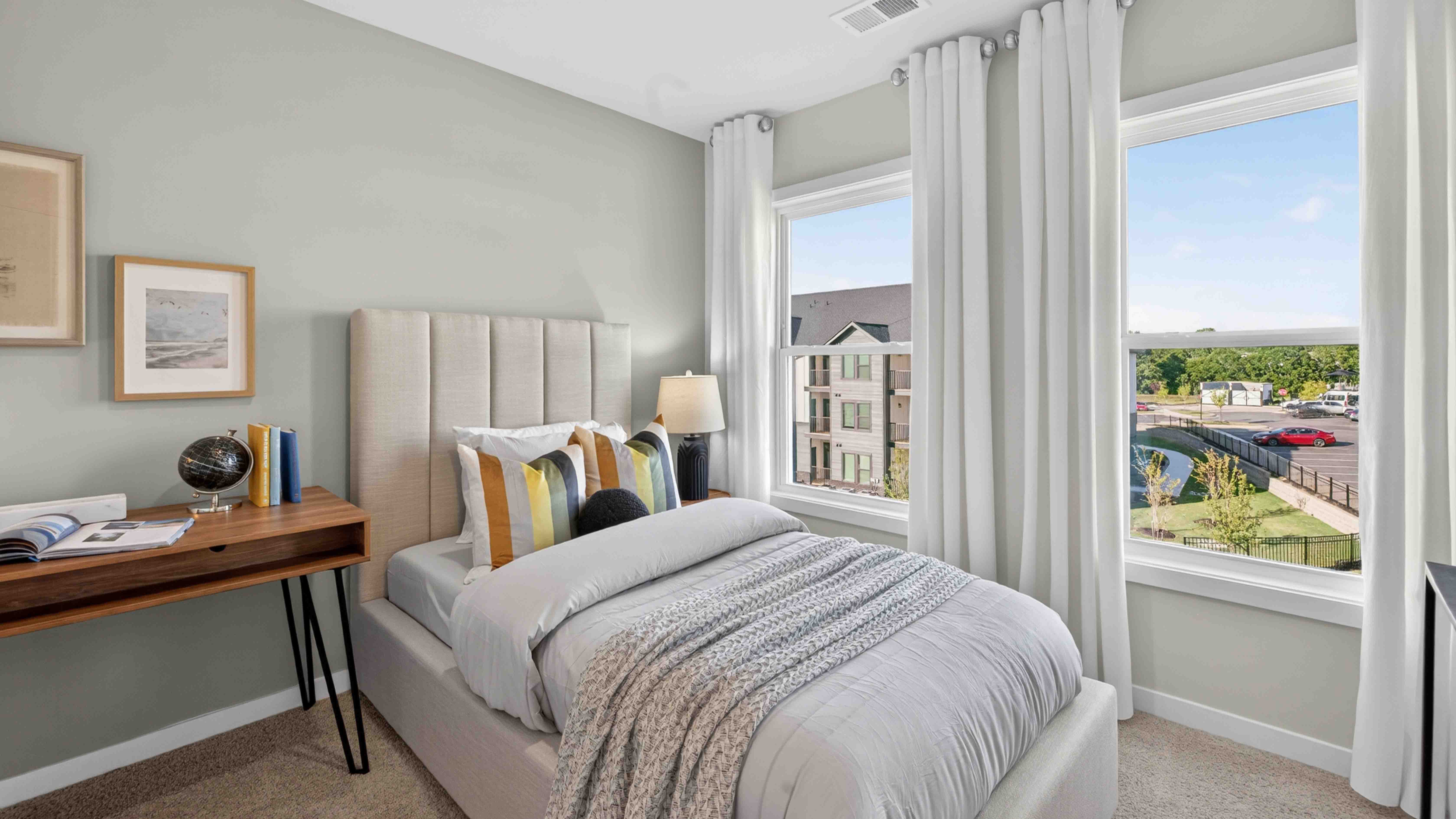 Carpeted bedroom with windows