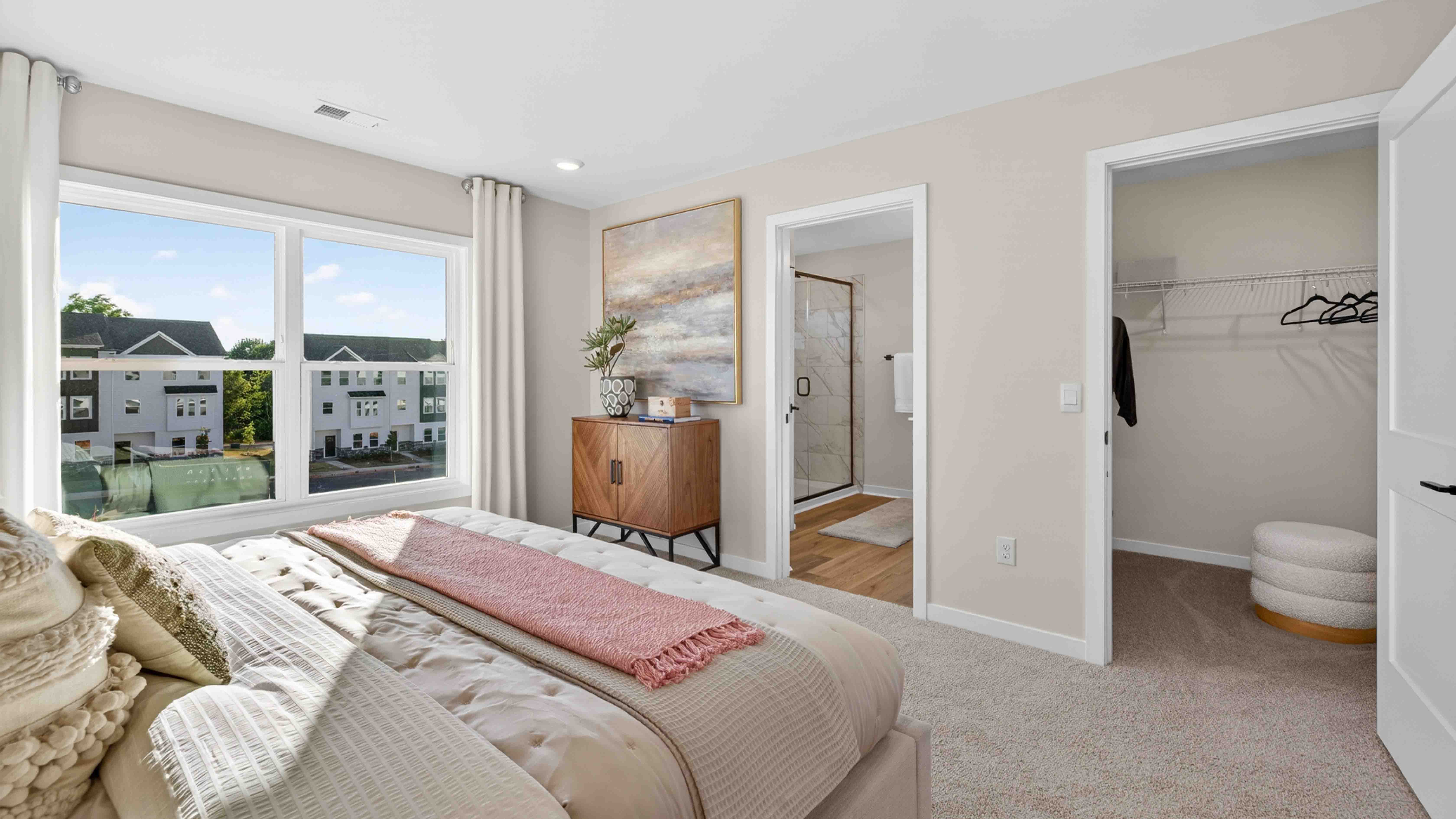 Primary carpeted bedroom with windows