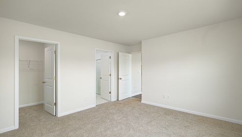 Carpeted bedroom, view of entrance door