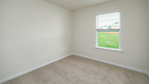 Carpeted bedroom with large window