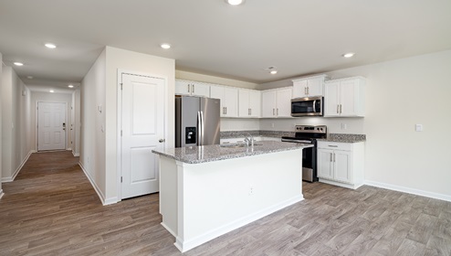 Open kitchen and island with white cabinets