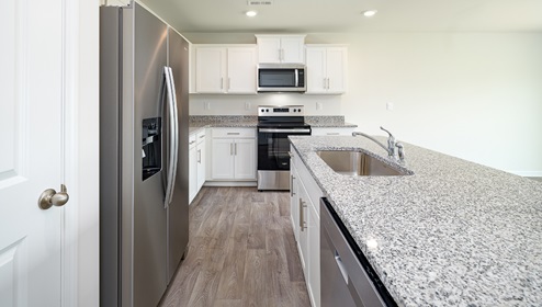 Open kitchen and island with white cabinets