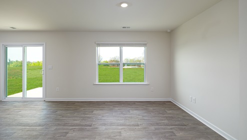 Great room with sliding glass doors, wood floors, and large window