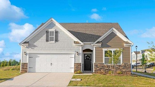 Aria front exterior with brown and white siding, stone and two car garage