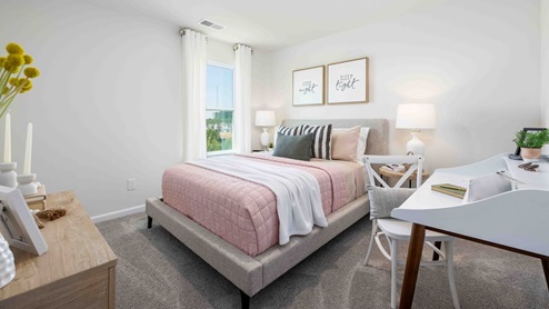Carpeted bedroom with small window