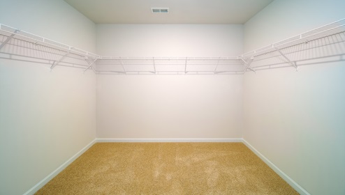 Primary walk in closet with racks