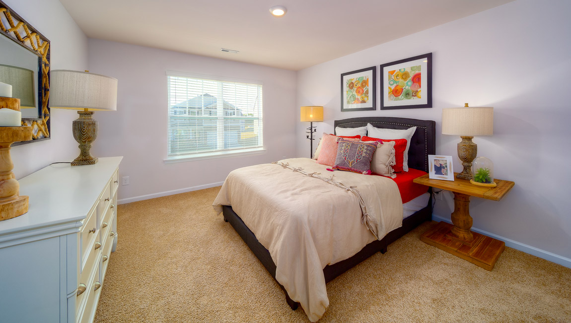 Carpeted bedroom with large window