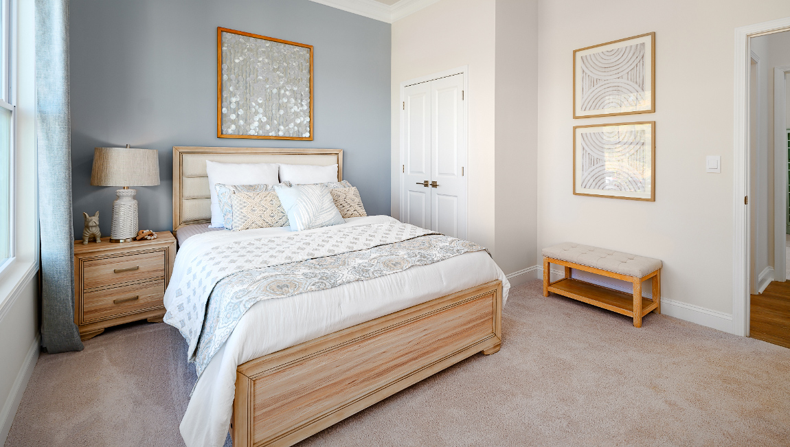 Carpeted bedroom three large windows