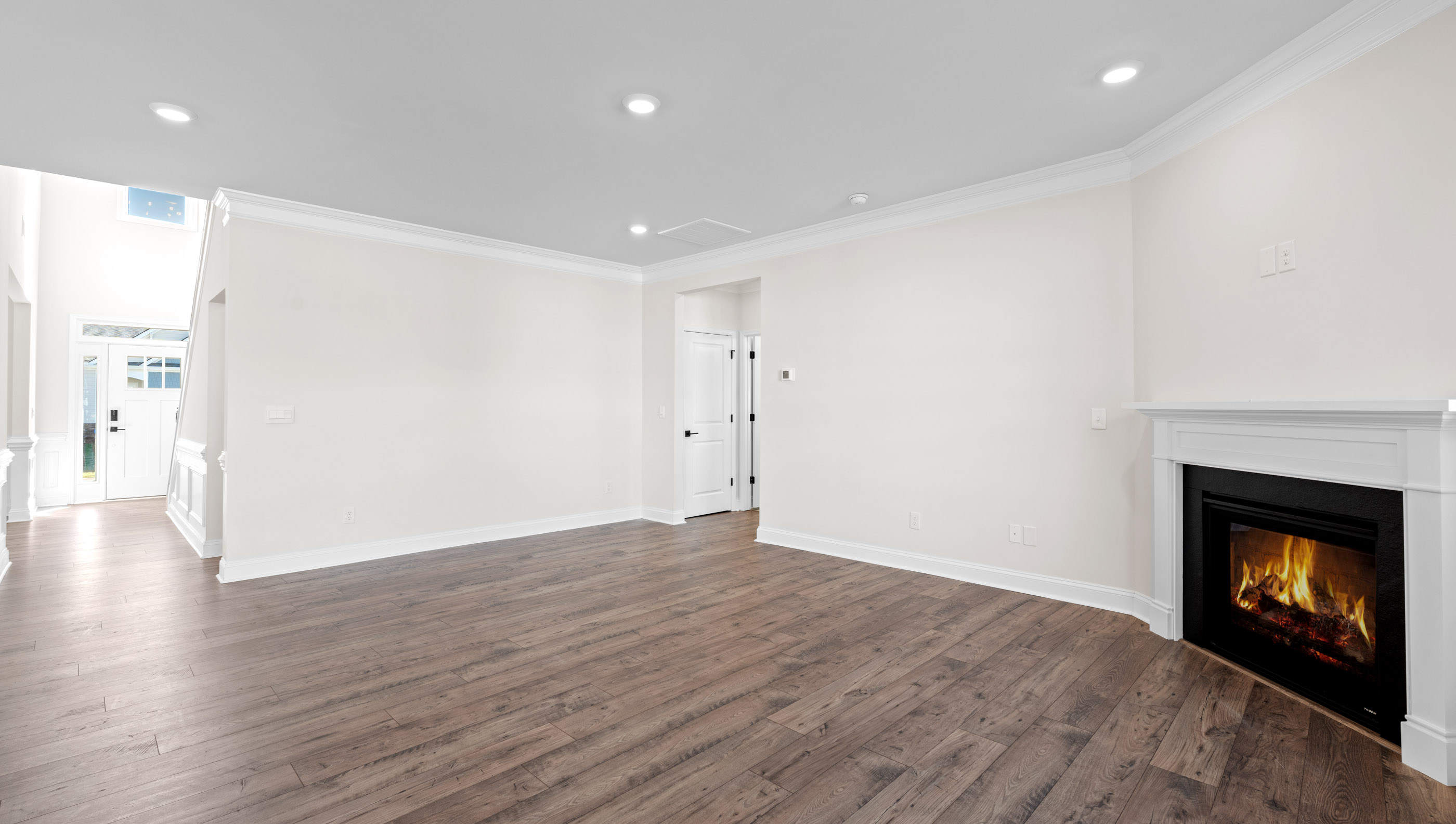 Family room with wood floors and fireplace