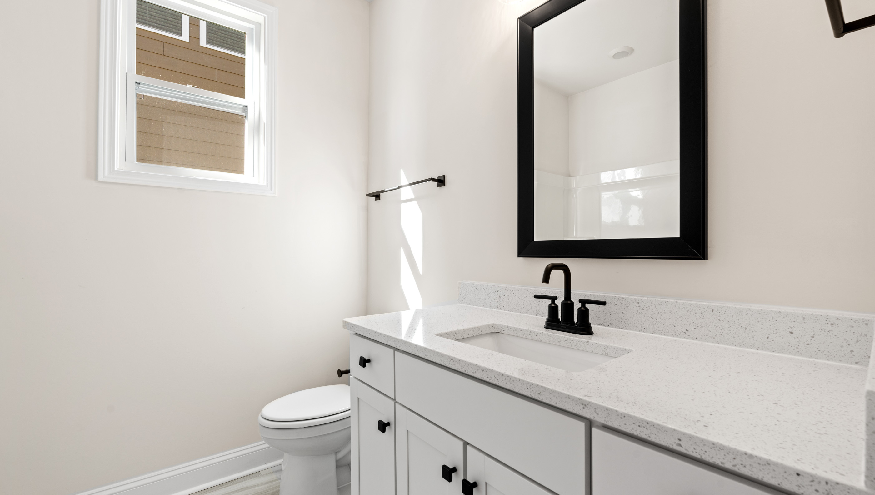Bathroom with bathtub and white cabinet