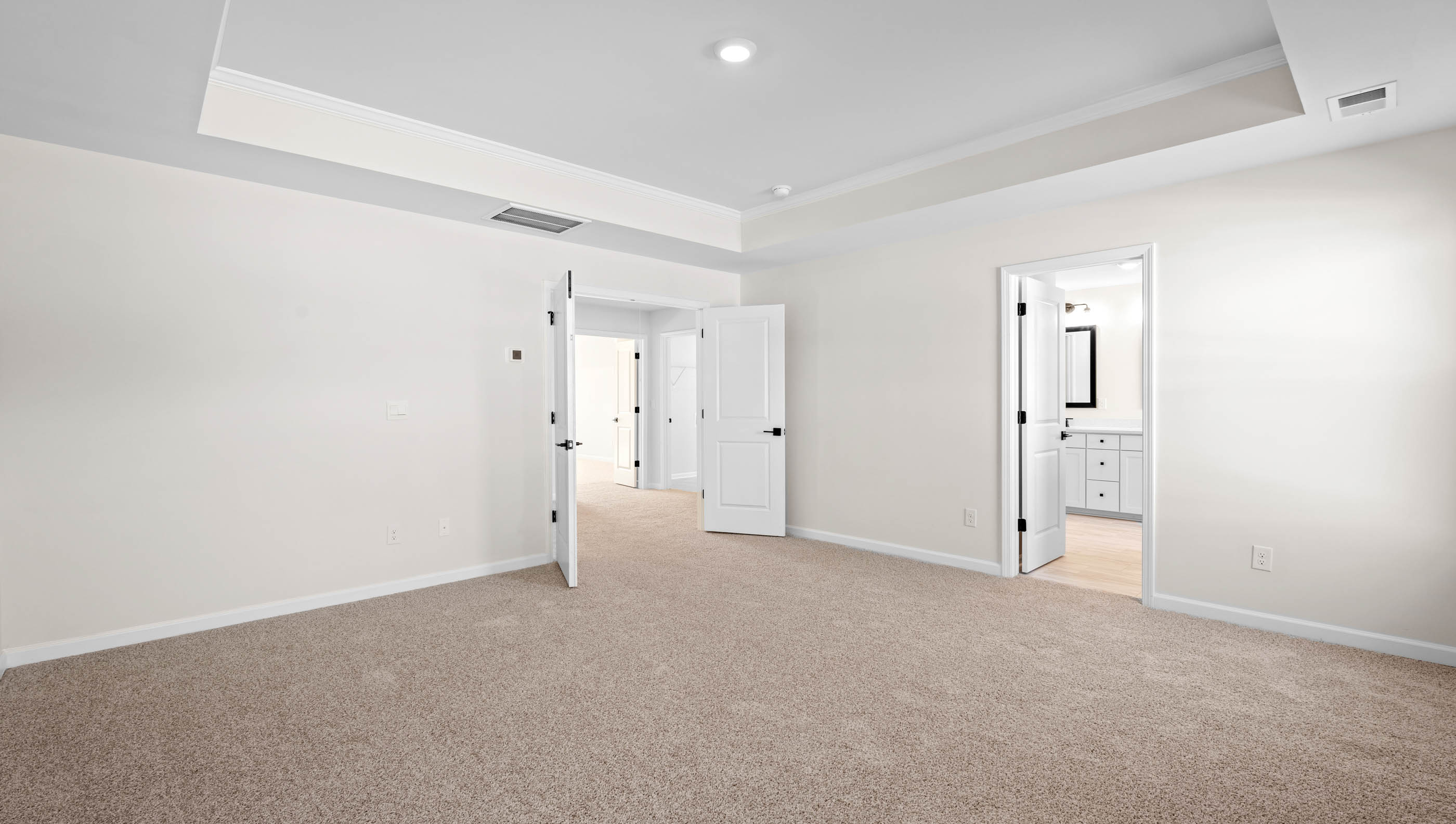 Primary suite carpeted with two windows