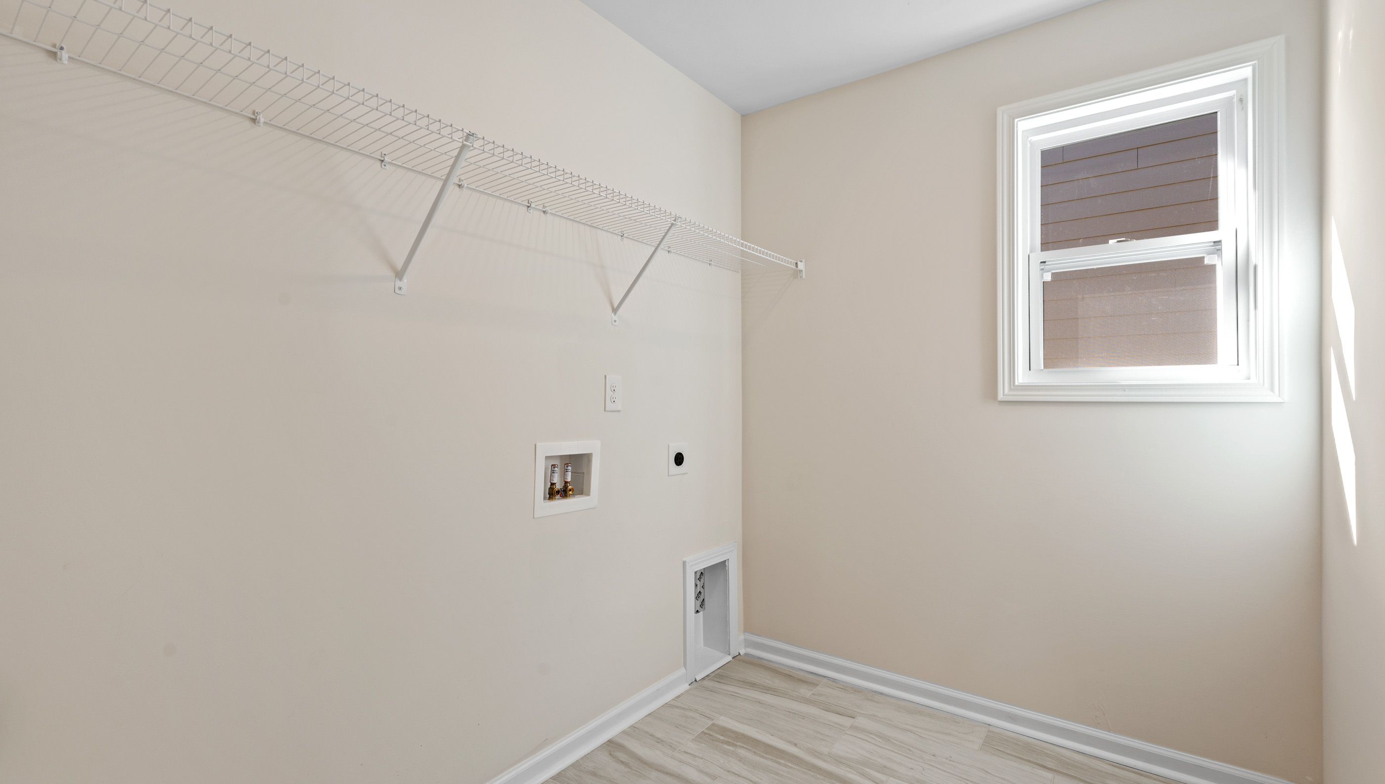 Laundry room with built in racks above machines