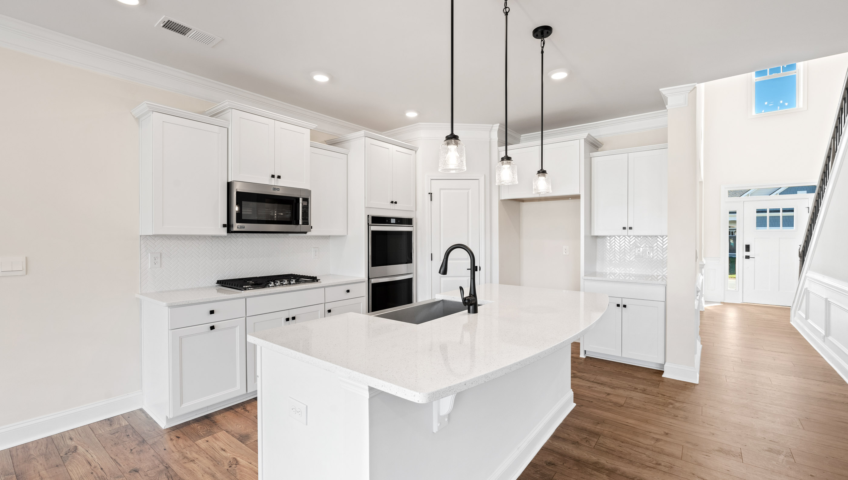 Kitchen and island with white cabinets