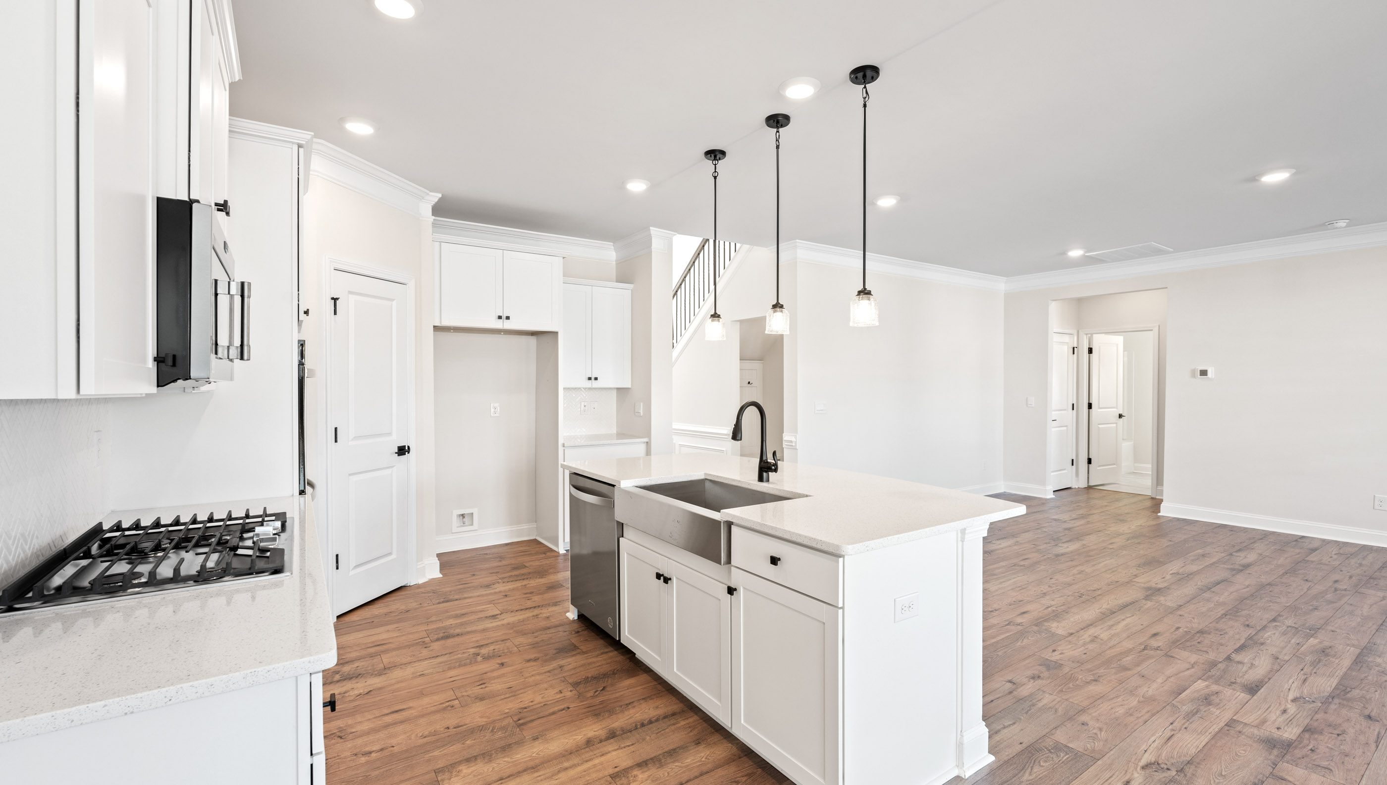 Kitchen and island with white cabinets