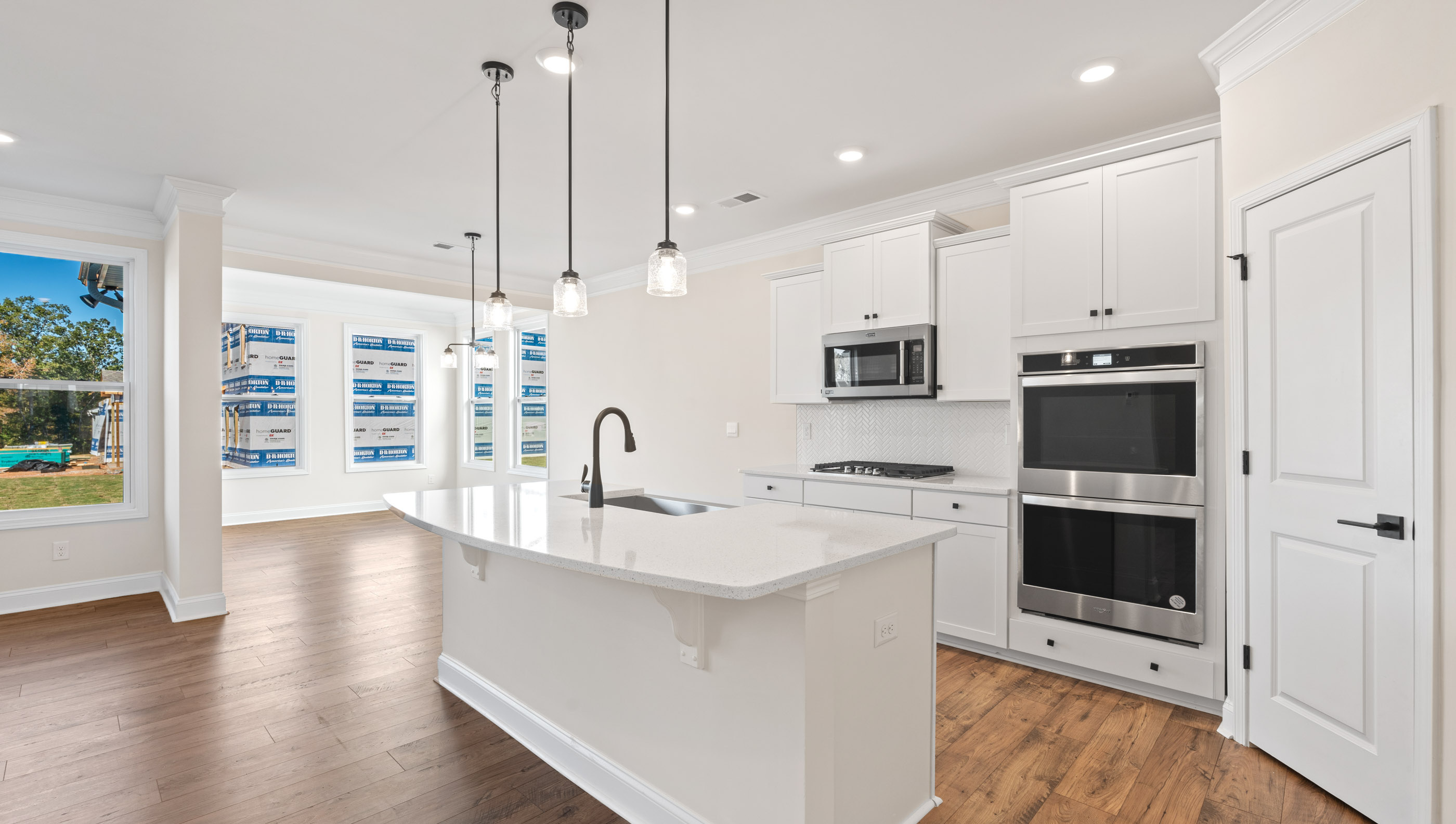 Kitchen and island with white cabinets