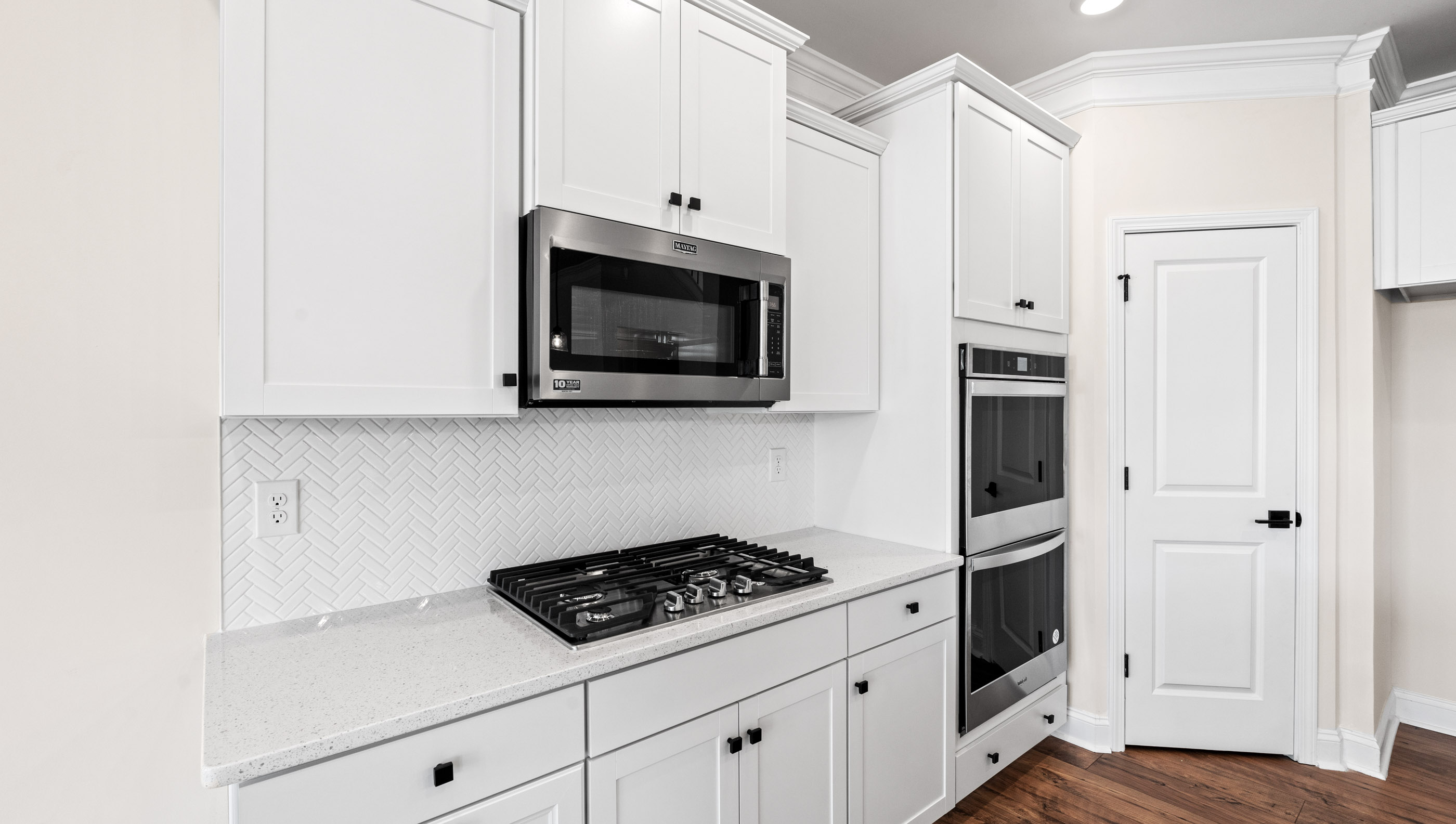 Kitchen and island with white cabinets