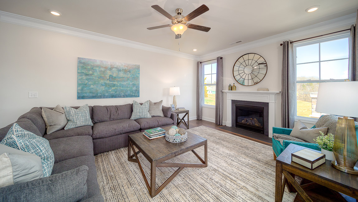 Open family room with two large window and fireplace