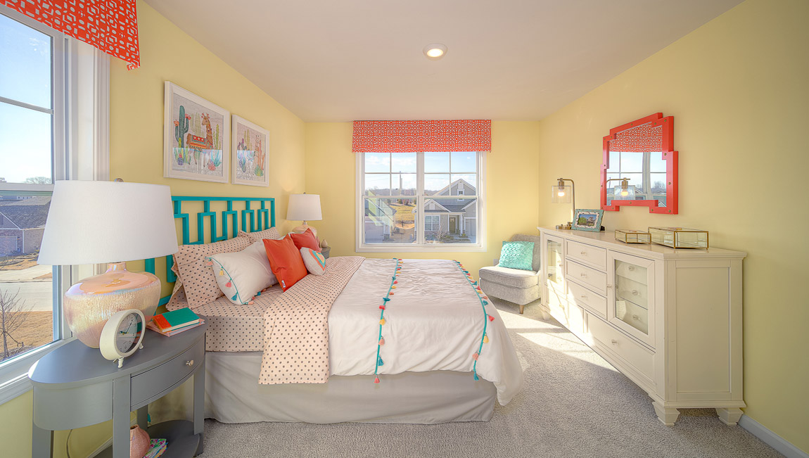 Carpeted bedroom with large windows