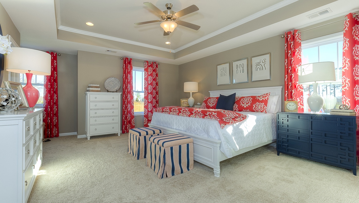 Primary bedroom with carpet and large windows