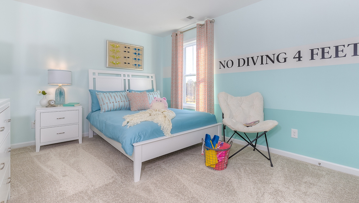 Carpeted bedroom with small window