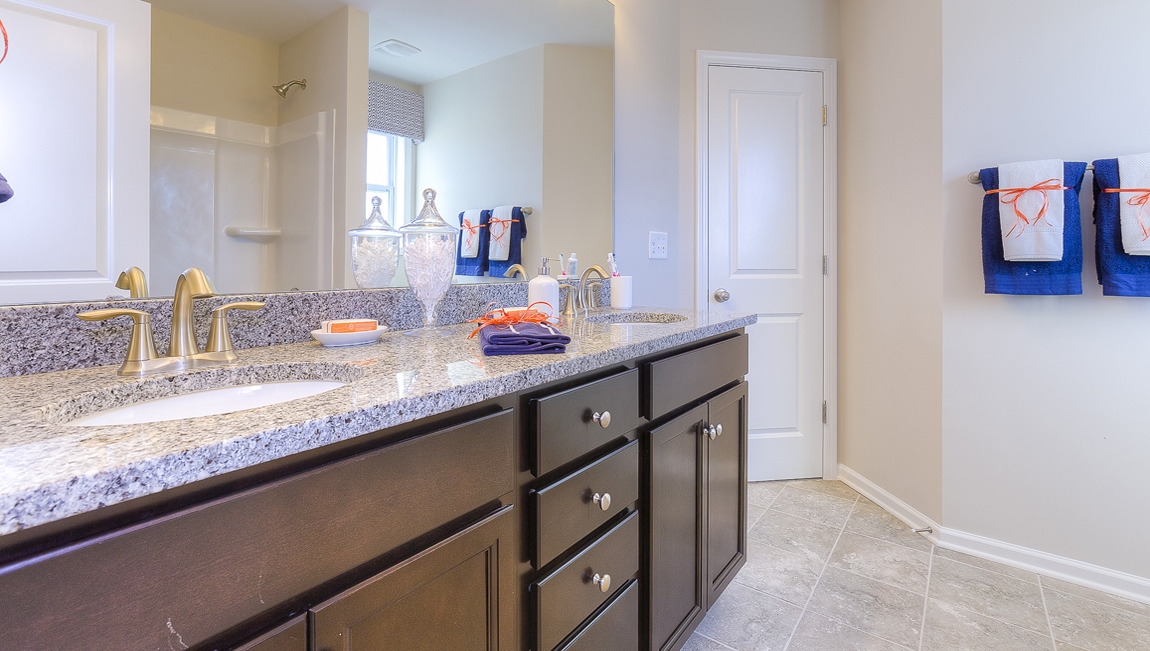 Bathroom with brown cabinets and bathtub