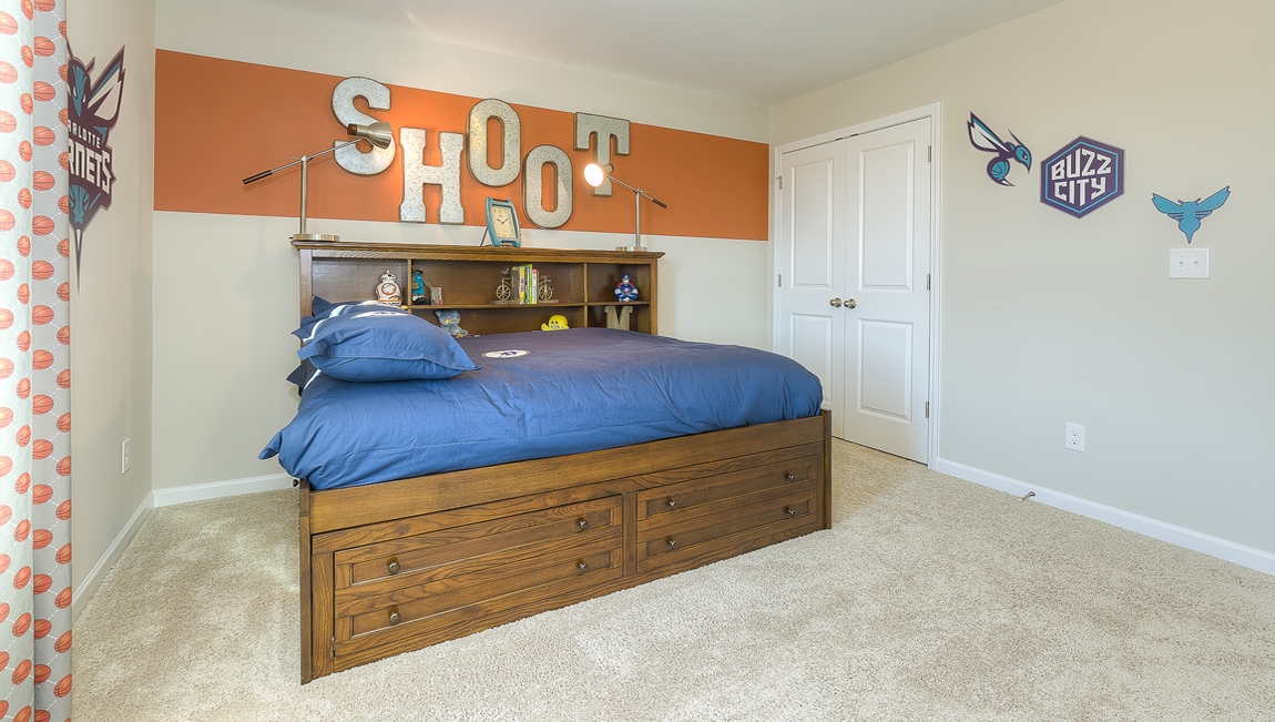 Carpeted bedroom with small window