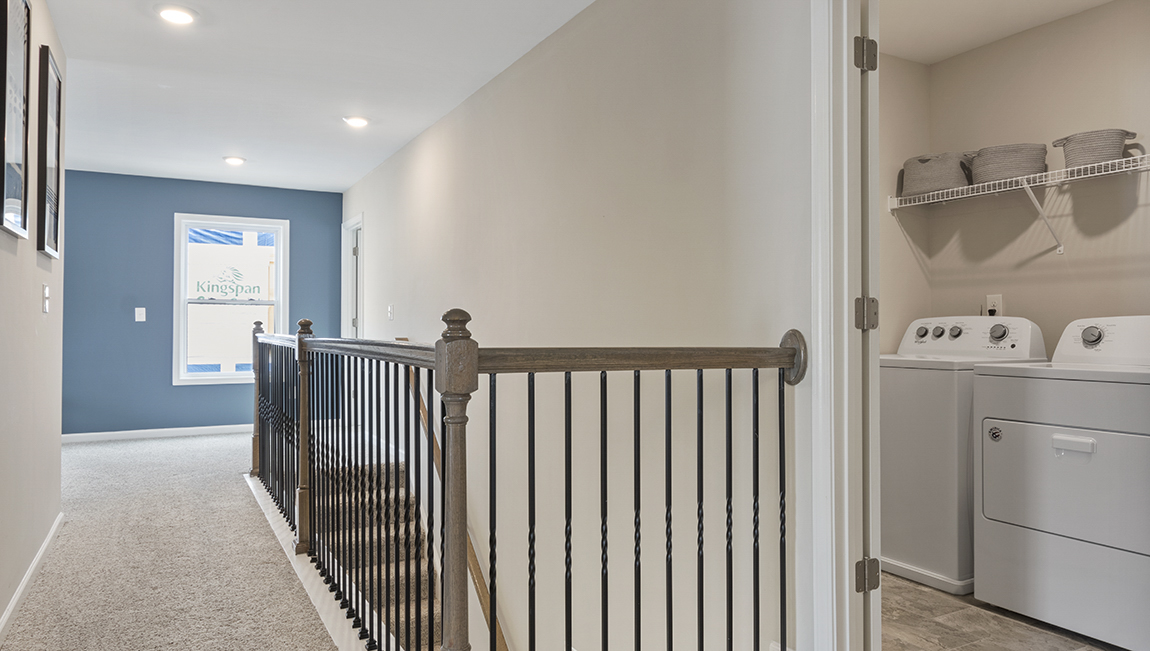 Upstairs hall, carpeted, with view of laundry room