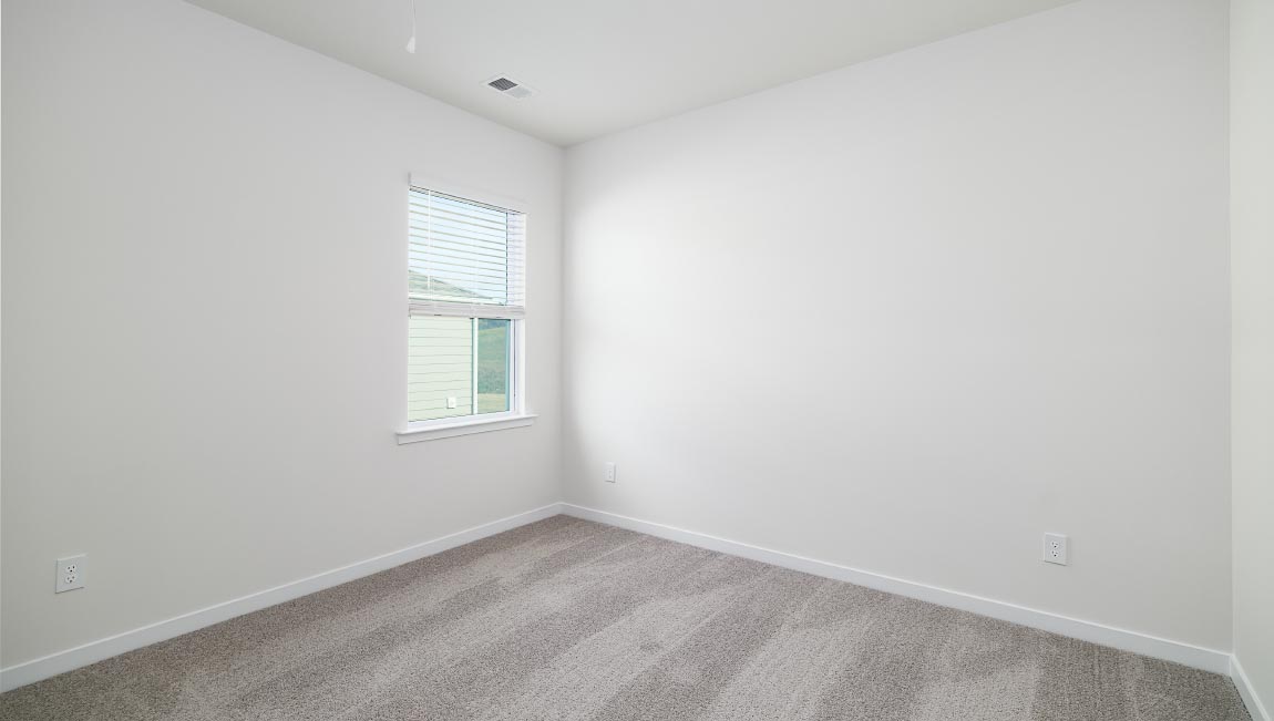 Carpeted bedroom with large window