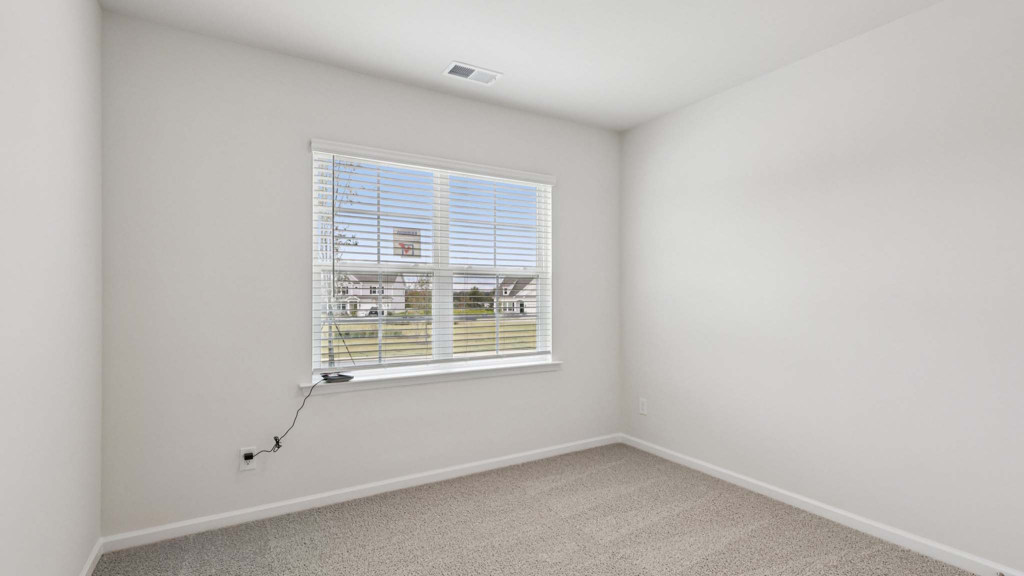 Carpeted bedroom with large window