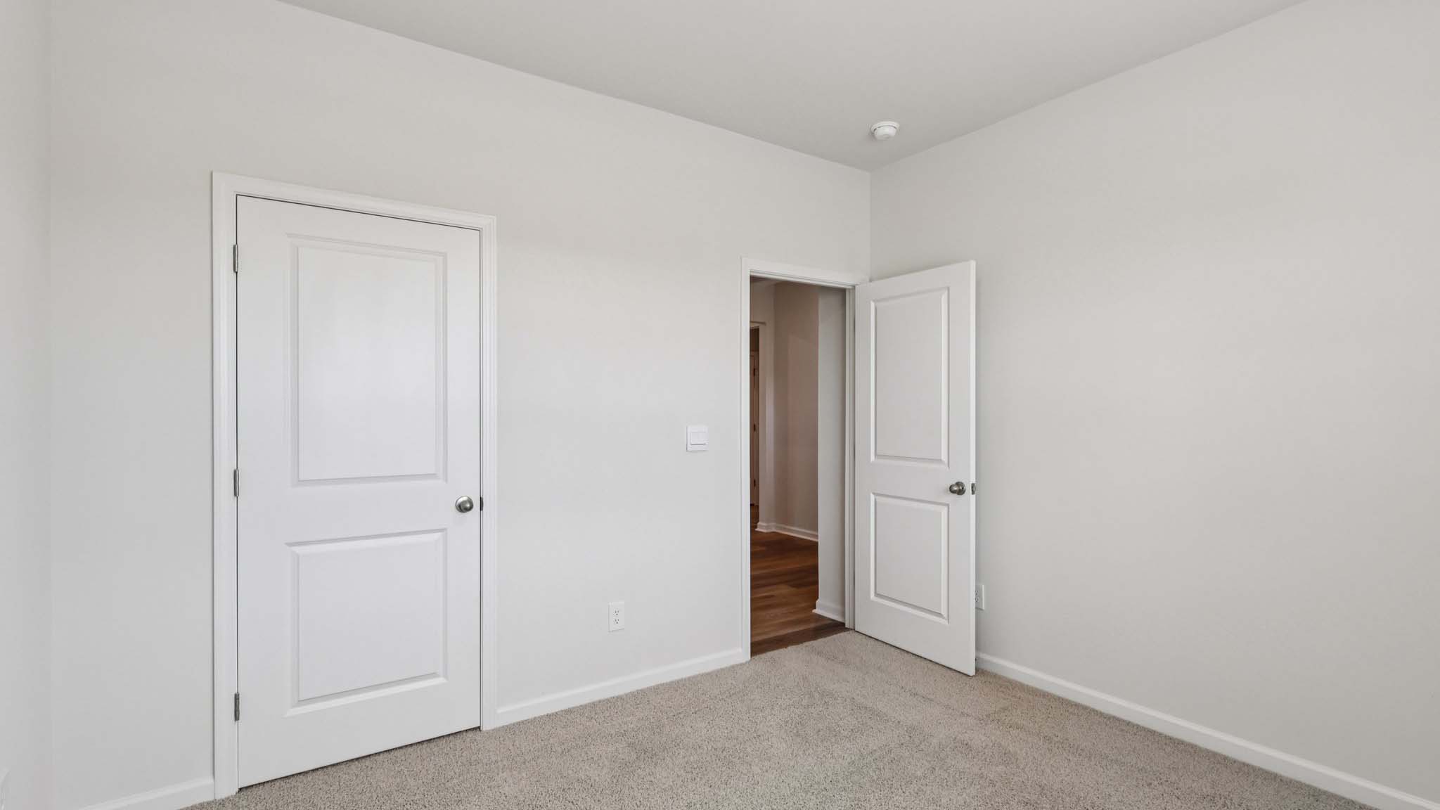 Carpeted bedroom with large window