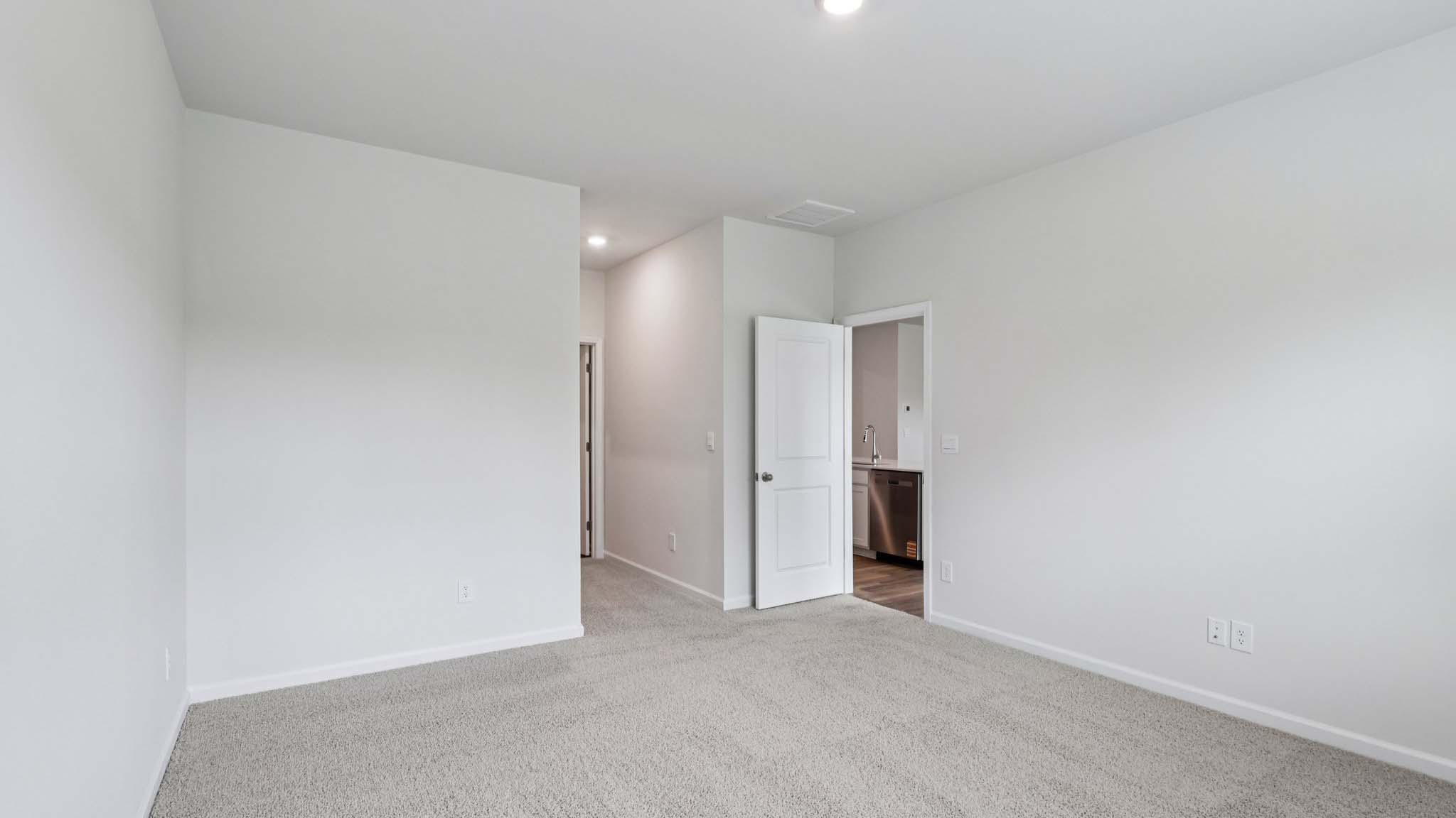 Carpeted bedroom with large window