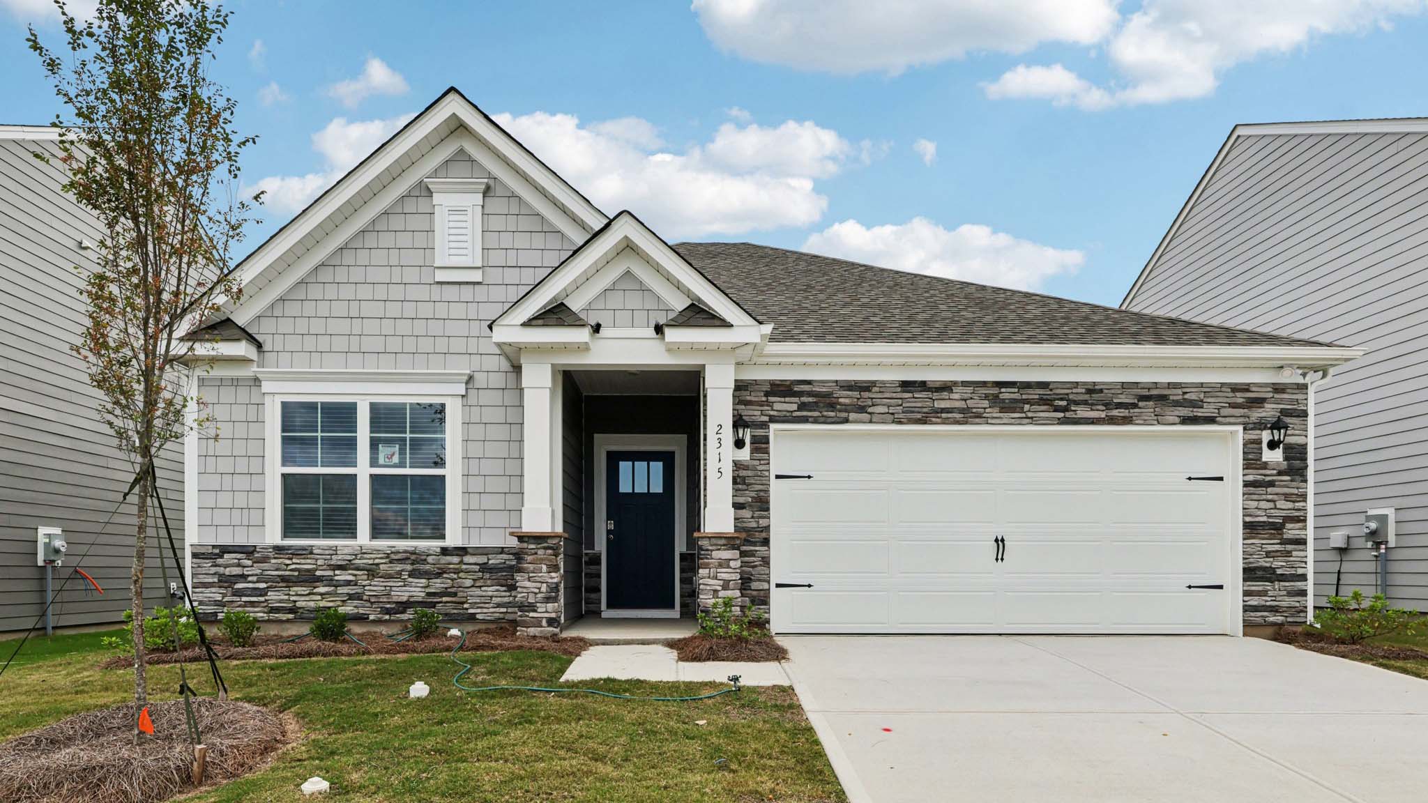 Aria front exterior with siding and garage