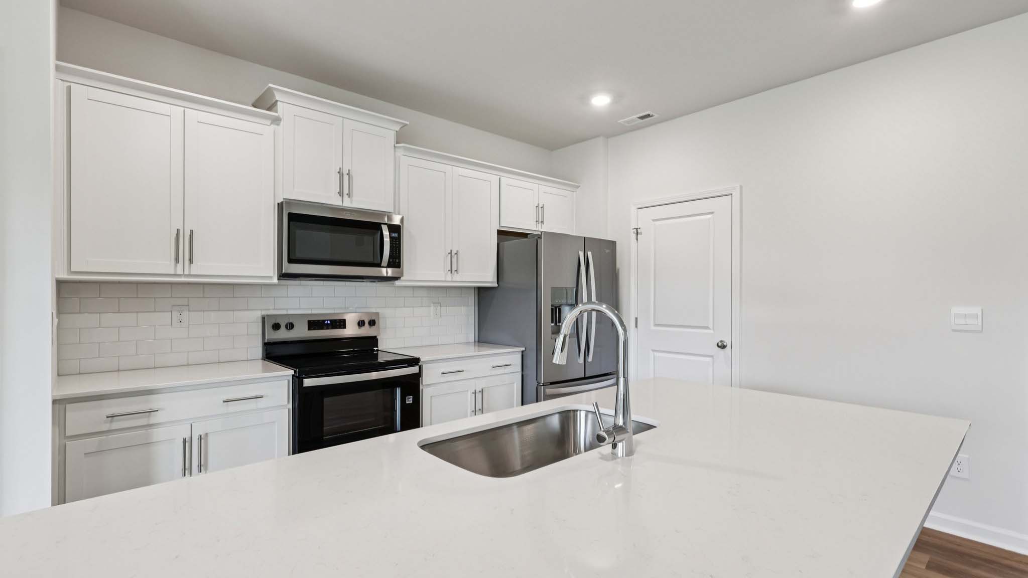 kitchen and island with stainless steel appliances